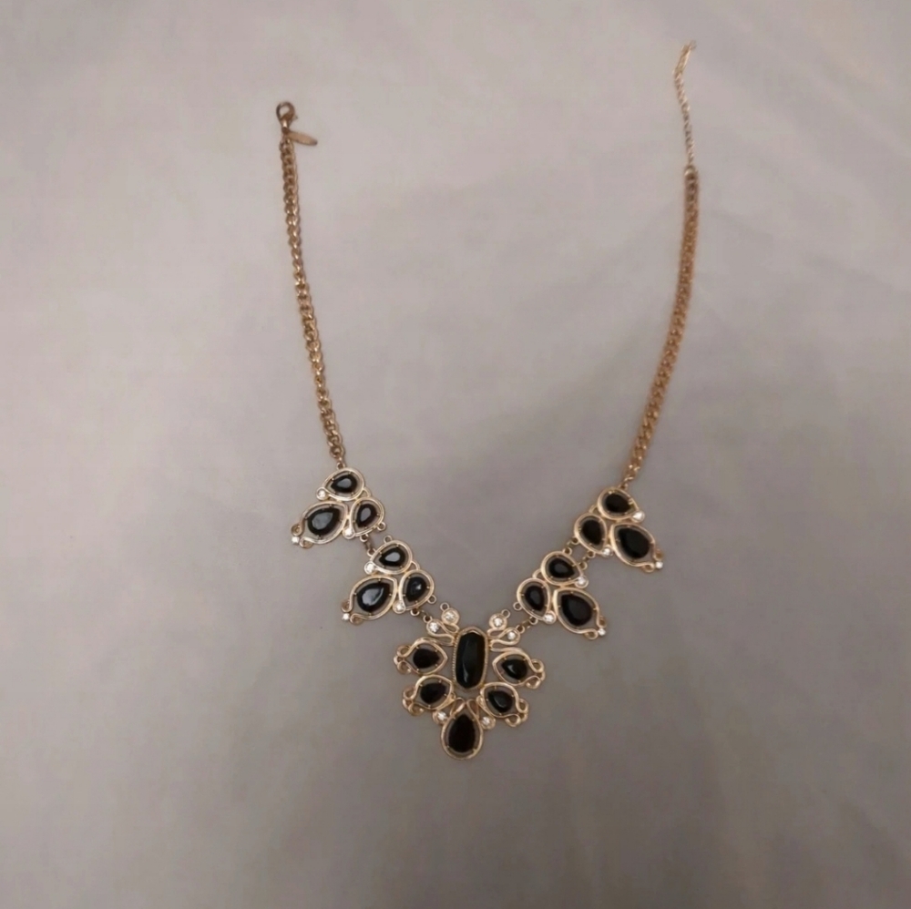 gold and black necklace
